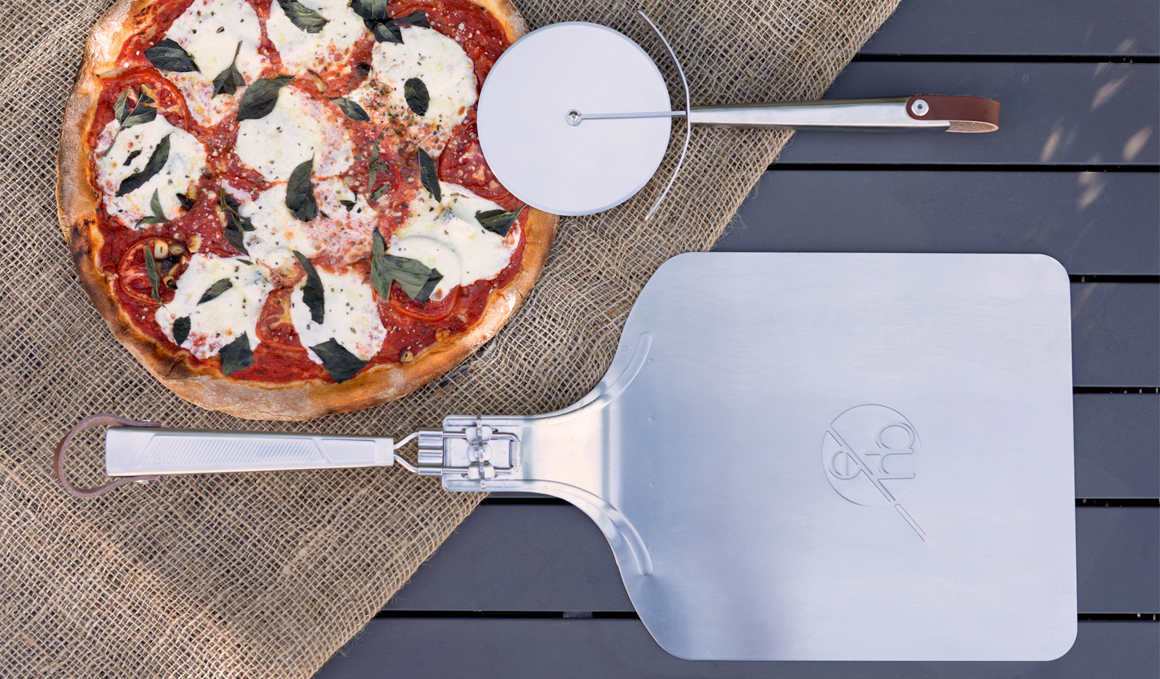 Quantum steel pizza cutter and pizza Peel top down flat lay